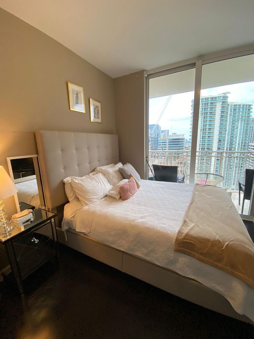 Tidy bedroom with a neatly made bed after cleaning