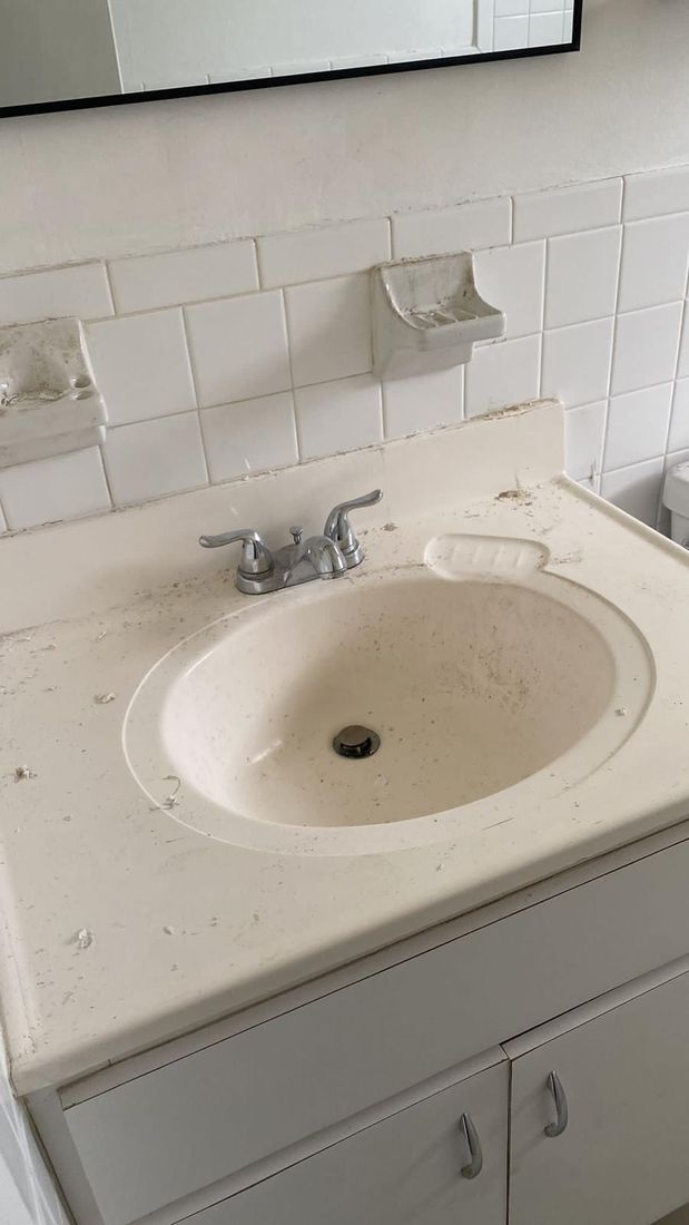 Bathroom sink with residue and buildup before cleaning